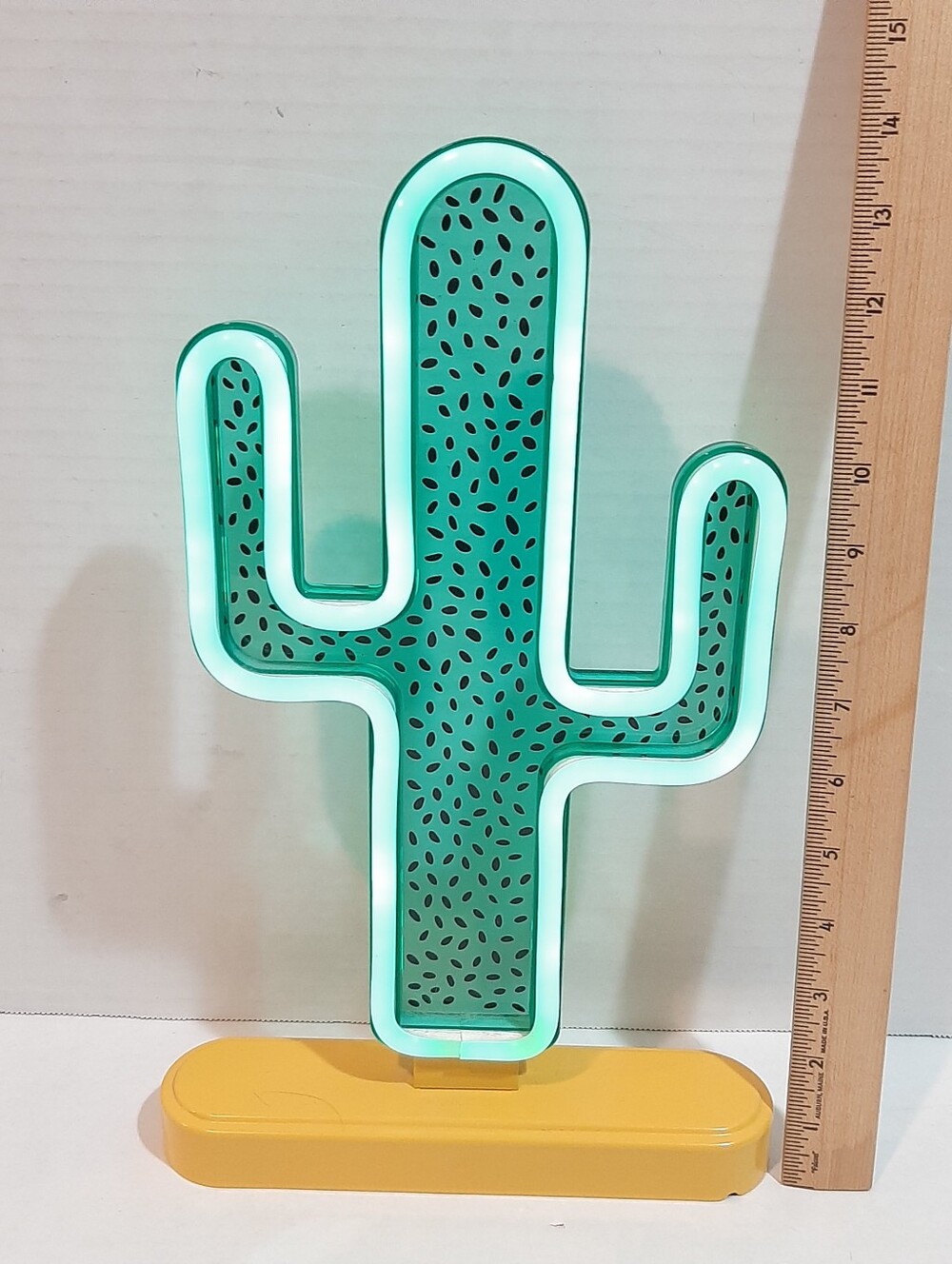 Green tabletop faux-neon cactus decorative sign with a yellow base